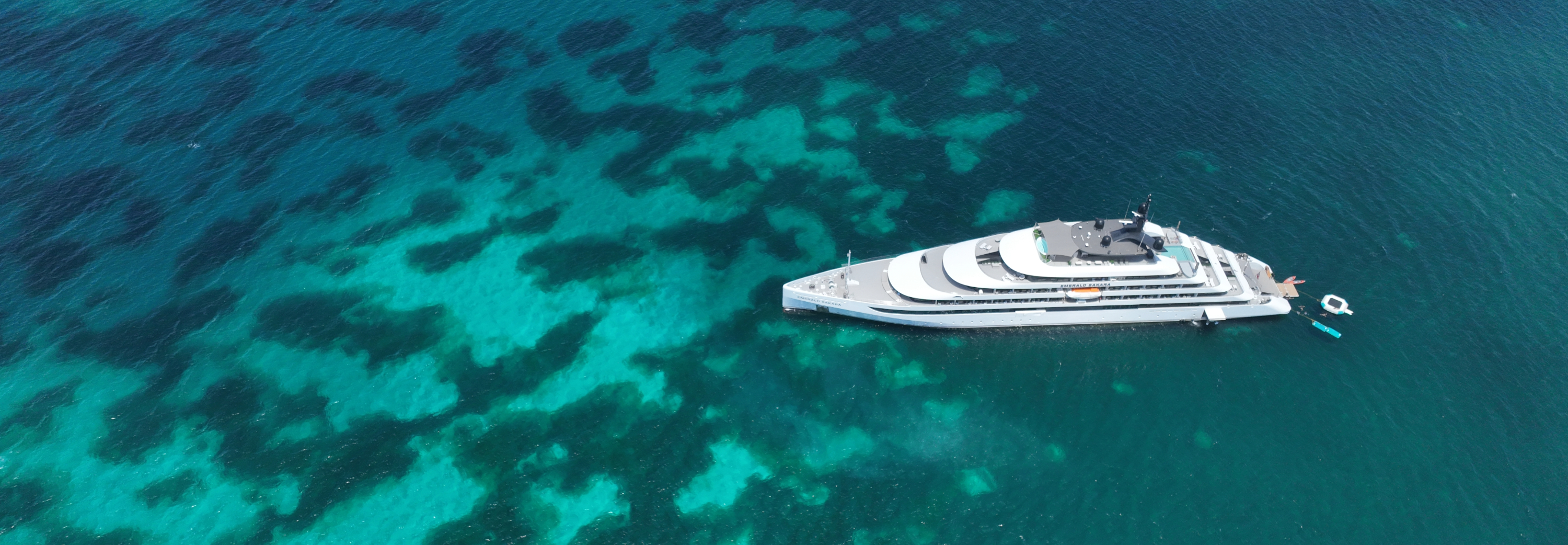 Emerald cruise yacht sailing in turquoise caribbean sea